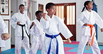 Kids, karate and class with fighting kata for self defense training, taekwondo or martial arts. Children, learning and practice session with kicking and punching for sport or lesson in aikido dojo