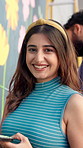 Girl, painter and smile with mural on wall for flowers, art and design for community in urban town. Woman, portrait and happy with social responsibility, creative and volunteer for building in city