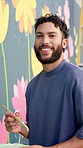 Man, painter and face with mural on wall for flowers, art and pride for community project in town. Person, portrait and happy with social responsibility, creative and volunteer for building in Mexico