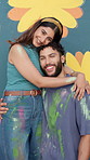 Couple, face and hug by flower painting on wall, creative bonding and love with happiness for DIY art project. Man, woman and portrait embrace with painter team, support and aesthetic floral design
