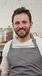 Happy, man and face of barista in coffee shop with confidence for service career in restaurant. Smile, customer service and portrait of male waiter with pride for hospitality in startup cafeteria.