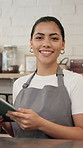 Face, barista and woman with tablet in cafe for online sales, order update and service. Technology, coffee shop and portrait of happy waitress on internet for reviews, stock or planning menu in Spain