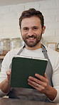 Face, barista and man with tablet in cafe for online sales, order update and check inventory. Technology, coffee shop and portrait of happy waiter on internet for reviews, stock and planning menu