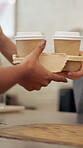 Hands, cup and customer in coffee shop, takeaway and purchase of hot beverage, barista or morning. Hospitality, consumer and server with package in small business, people or sale of breakfast in cafe