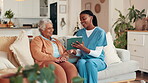 Senior woman, nurse and tablet at house for good news, healthcare report and medical results. Elderly person, caregiver and laugh with digital for advice, diagnosis information and explain treatment