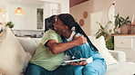 Support, hugging and senior man with nurse on sofa for good news, help or healing with treatment. Happy, thank you and caregiver embracing elderly male patient in living room at nursing home.