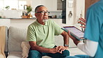 Senior man, nurse and tablet at house for consultation, healthcare checkup and medical report. Elderly person, caregiver and talking with digital for advisory, diagnosis results and explain treatment