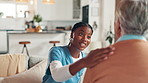 Nurse, home and senior woman with support, smile and conversation with positive news. Old patient, medical or professional in lounge, empathy or good feedback with retirement, volunteer or kindness