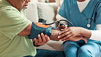 Senior man, hands and nurse with blood pressure exam in home for cardiovascular health or wellness. Caregiver, cuff or medical test for hypertension, check or help to measure heart rate in retirement