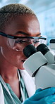 Black woman, scientist and medical research with microscope for forensic science or medical discovery at lab. Female person, health worker or biologist with technology for microscopic examination