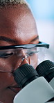 Black woman, scientist and research with microscope for forensic science or medical discovery at lab. Female person, health worker or biologist with technology for microscopic examination or results