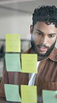 Planning, sticky notes and business man in office with idea for brainstorming, strategy and project schedule. Creative agency, thinking and person by glass wall for agenda, research and information