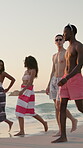 Relax, walking and travel with friends at beach for summer vacation, adventure and happy. Tropical destination, trip and break with group of people in nature for tourism, holiday and bonding together