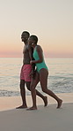 Beach, holding hands and black couple with vacation, smile and bonding together with laughing. People, ocean and man with woman, nature and love with joke, honeymoon and relationship with holiday