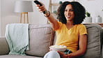 Snack, remote and woman watching television on sofa for entertainment in living room. Relax, popcorn and female person with streaming subscription for movies, film or series in lounge at apartment.