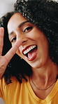 Peace sign, selfie and face of woman in home with emoji for social media, recording video and post. Happy, smile and portrait of person blowing kiss for photograph, picture and fun in living room