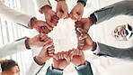 Hands, business people and fist in circle in office for team building with support, synergy or solidarity at company. Group, huddle and low angle for motivation, together or scrum at finance agency