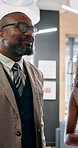 Discussion, smile and businessman in lobby for project, schedule update or conference hall advice. Mentor, teamwork and keynote speaker in meeting for networking, seminar or career event review