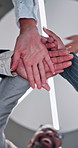Business people, meeting and below with hands together for teamwork, community or organization at office. Low angle, group or happy employees piling with stack or unity in solidarity for mission