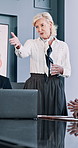 Woman, explain and meeting in office for business, investment proposal and hosting presentation. Mature speaker, talking and colleagues in workplace for budget discussion, brainstorming and advice