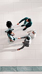 Handshake, above and meeting with business people at conference for introduction, partnership and welcome. Tradeshow expo, networking event and shaking hands with group of employees for b2b forum