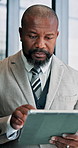 Business, black man and typing on tablet in office for reading email, financial report and management. Male person, digital and research with schedule update, budget planning and investment feedback