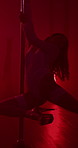 Pole dancer, woman and dance with neon light on stage for exotic performance, spin and flexibility in entertainment club. Night, performer or private show on floor with sensual movement and burlesque