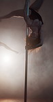 Pole dancing, woman and performance at club, flexible and creativity with neon, art and concert at night. Person, exotic dancer and costume for private show, balance and fantasy on stage with smoke