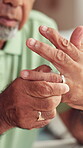 Divorce, hands and old man with ring removal for toxic marriage, relationship conflict and contemplation. Closeup, senior person and doubt with infidelity, secret affair and mental health in home