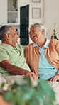 Senior couple, laugh and talking on sofa with funny memory, love and bonding with care in living room. Elderly people, man and woman on couch with comic conversation, joke and nostalgia in retirement