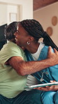 Hug, tablet and nurse with senior man for online help, insurance and medical support. Happy, retirement home and caregiver with mature person on digital tech for telehealth, results and good news