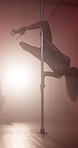 Woman, pole dance and legs at club, performance and creative with neon, smoke and burlesque concert. Person, exotic dancing and swivel for private show, stretching and fantasy on stage with talent