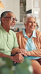 Senior, happy couple and listening with consultation for retirement, pension funding or agreement at home. Elderly, man and woman with smile on sofa for healthcare support or plan together at house