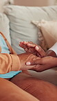 Nurse, empathy and holding hands with old woman on sofa for support, hospice care and kindness. Retirement home, caregiver and discussion with senior patient in living room for healthcare advice