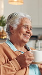 Coffee, talking and senior woman on sofa with warm drink for speaking and conversation in home. Retirement, living room and mature person with beverage, tea or caffeine for rest, comfort and chat