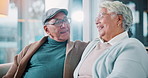 Conversation, bonding and retirement with senior couple on sofa in living room of home together. Happy, hug or laughing with old man and woman in apartment for relationship, relax or romance