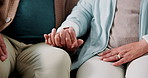 Holding hands, love and support with senior couple on sofa in living room of home together. Empathy, safety or security with old man and woman in apartment for relationship, romance or trust