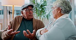 Argument, conflict and senior couple on sofa in living room for divorce, separation or breakup. Fighting, upset and elderly people for marriage crisis, disagreement or communication problem in home.