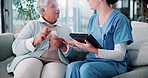 Senior woman, nurse and pills with tablet on sofa for discussion, guide and listen for medicine schedule in lounge. Elderly person, caregiver and pharma drugs with app on couch in retirement home