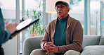 Advice, counseling or tablet with patient and therapist on sofa in clinic for consulting or help. Healthcare, medical or support with counselor and senior man in office for anxiety or psychology