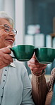 Home, cheers and old couple with coffee, smile and senior woman with hot beverage, drinking and lounge. House, toast and elderly people with tea in living room, relax and celebration for retirement