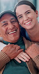 Elderly man, face and caregiver with hug for support, assisted living and care in retirement home. Senior person, nurse and happy in lounge for healthcare, relationship development and consultation