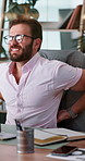 Businessman, injury or back pain with discomfort on computer for muscle tension or inflammation at office. Man, employee or spine ache with technology for bad posture, pressure or strain at workplace
