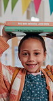 Face, girl and books on head at school for education development, knowledge and ready for learning. Balance, child student and happy with novels in classroom for language study, literature and growth