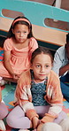 Girls, education and students on floor, school and storytelling with knowledge, relax and listening. Group, child development and kids on ground, academic learning and language with growth or teacher