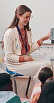 Children, teacher and lesson with flash cards at school for creative learning, memory recall and quiz answer. Education, people and happy with animal alphabet test for language, teaching or knowledge