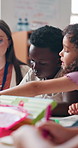 Kids, teacher and woman in classroom, education and conversation with help, teaching and writing Creativity, educator and employee in school, discussion and learning with academic growth and students