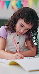 Writing, education and child with exam, classroom and knowledge for project, growth and development. Student, studying and kid with notebook for test, learning or girl with information for elementary