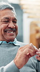 Senior man, typing or happy with phone for text message, playing online game or reading news blog. Retirement, elderly person or relax with smartphone in home for mobile chat or download internet app