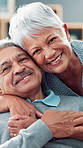 Hug, home and old couple with face, smile and bonding together with trust, relationship and care. Happy people, mature woman and senior man on sofa, embrace and marriage with love, relax and support